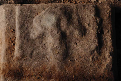 The head of the tombstone effigy with head resting on cushion
